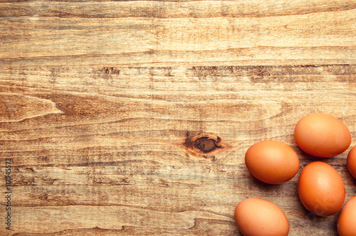 The image of eggs on a wooden table. photo