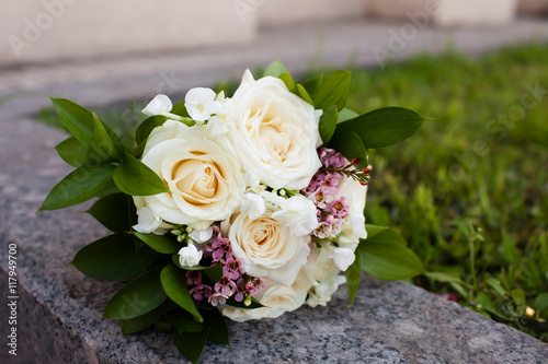 Bridal bouquet of beautiful roses for a wedding on wooden background