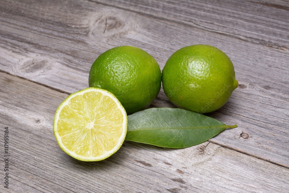 Fresh ripe limes on wooden table Fresh ripe limes on wooden table