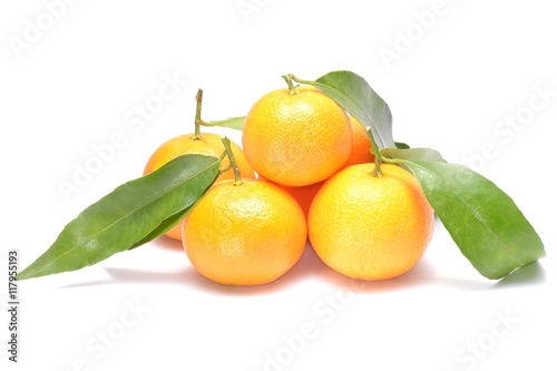 Ripe mandarin with leaves close-up on a white background