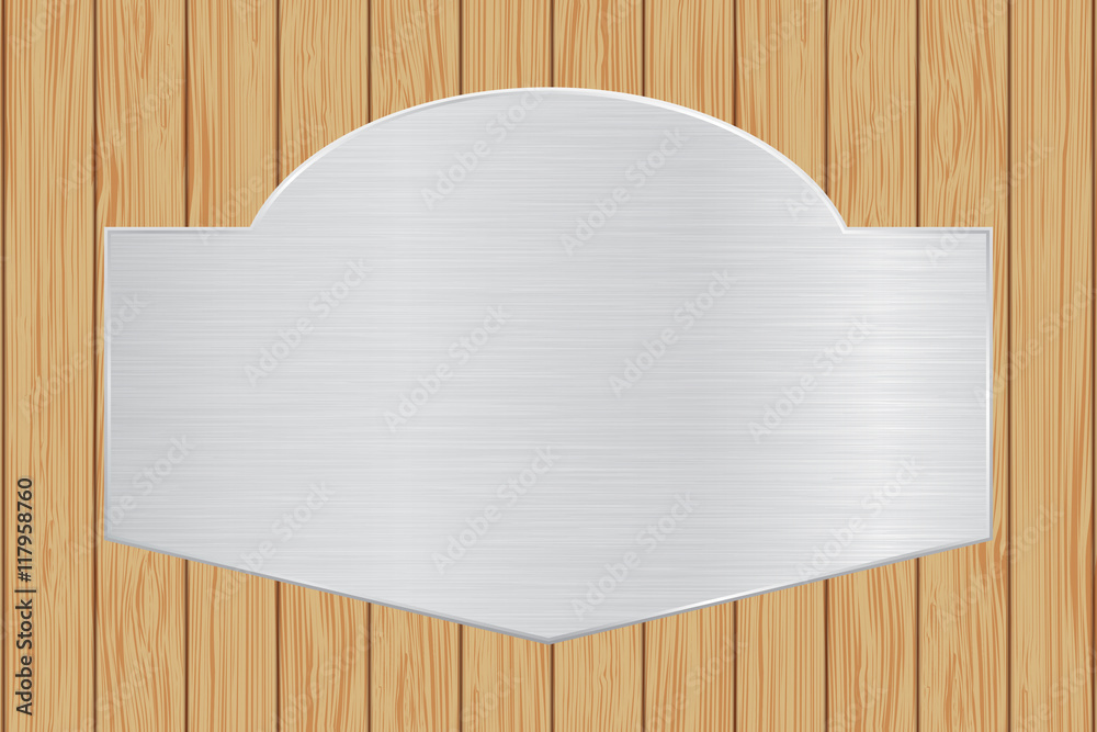 Metal plate on wooden background Metal plate on wooden background