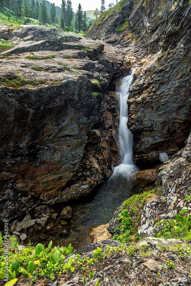 Waterfall on the river Kamenka in Khamar-Daban ridge Waterfall on the river Kamenka in Khamar-Daban ridge