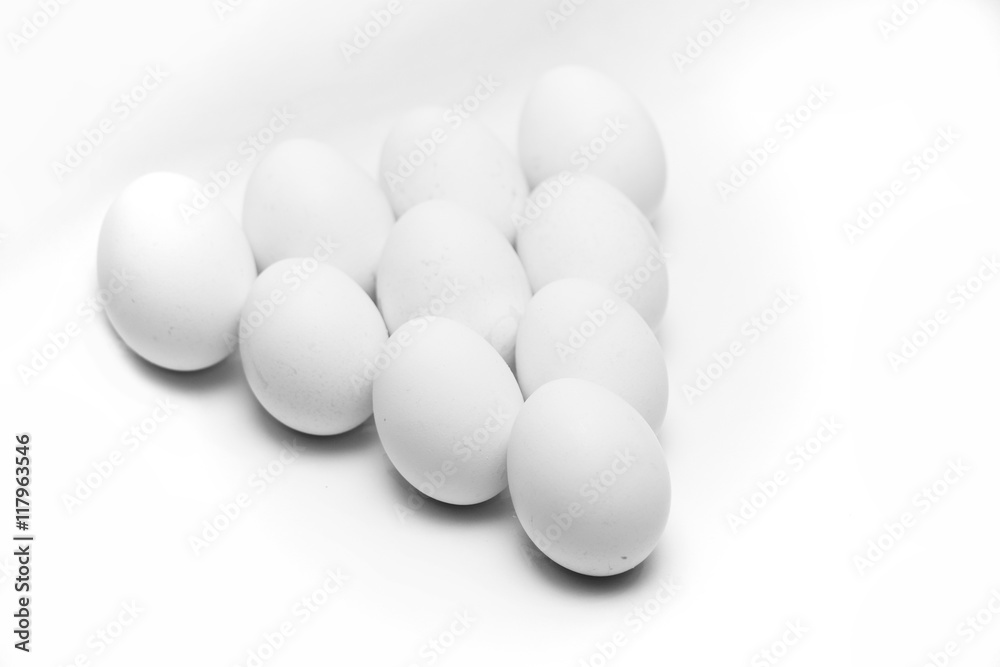 ten white eggs on white background