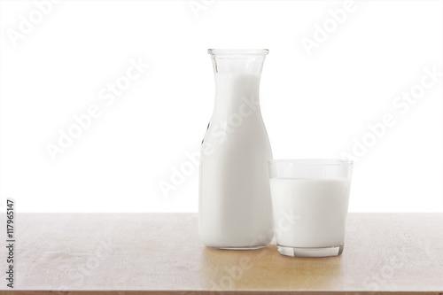 Bottle of milk and glass on wooden table on white background