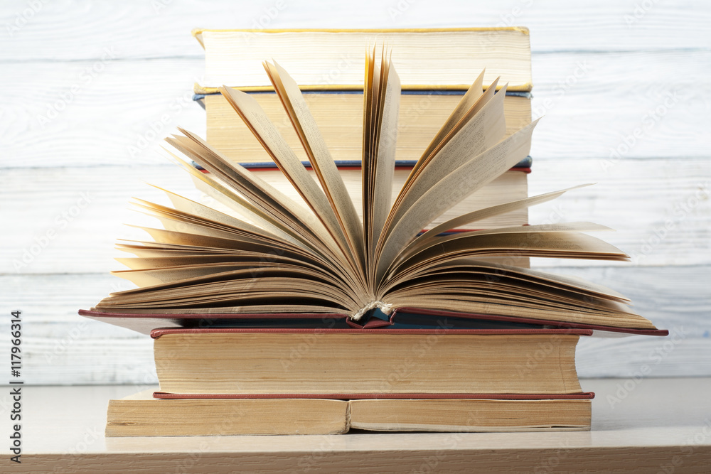 Open book, hardback books on wooden table. Education background. Back to school. Copy space for text. Open book, hardback books on wooden table. Education background. Back to school. Copy space for text.