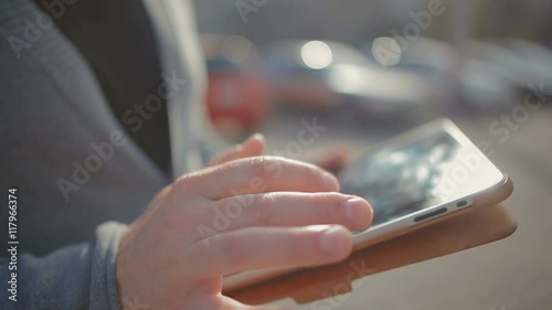Close-up of male hands which thumbs through a news feed and reads them