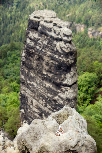 The Small cone Pravcicky and coins from tourists, Czech Switzerland National Park photo