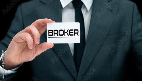 Young broker showing his business card.