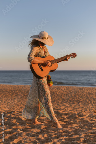 Guitar Playing Girl Beach Relaxation Song Music Concept photo