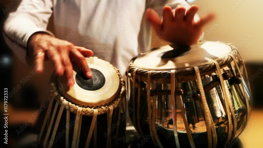 Close-up of man playing the tabla drum