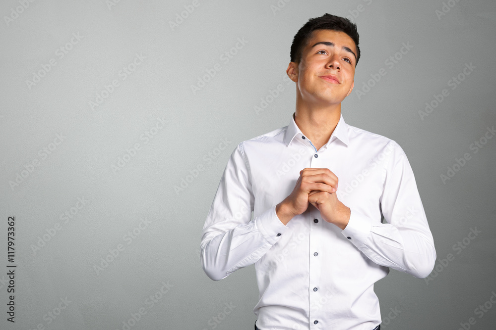 Closeup portrait of desperate young man showing clasped hands Closeup portrait of desperate young man showing clasped hands