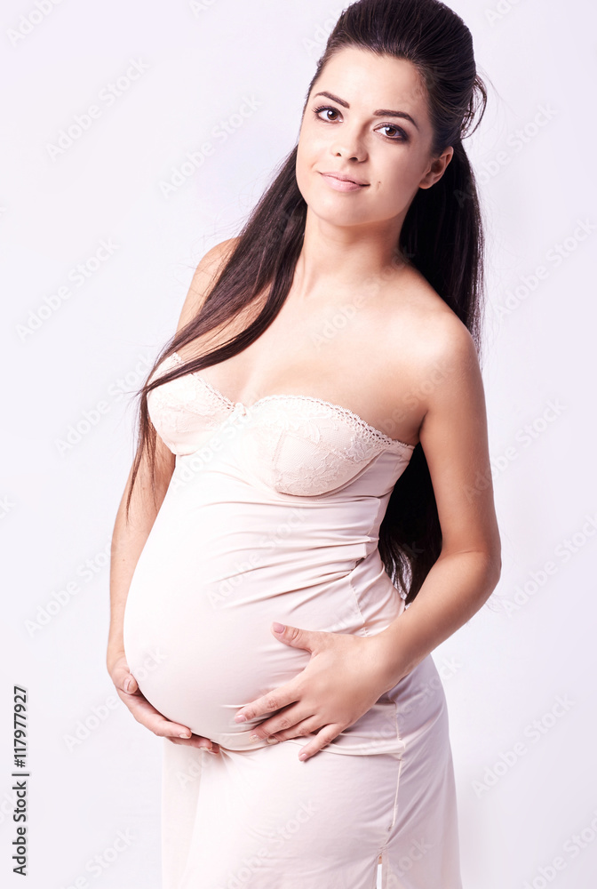 pregnant woman touching her belly