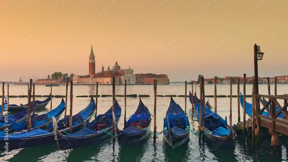 Parking gandolas on the Doge's palace embankment with the bell tower of the Saint Giorgio Maggiore church view. Parking gandolas on the Doge's palace embankment with the bell tower of the Saint Giorgio Maggiore church view.