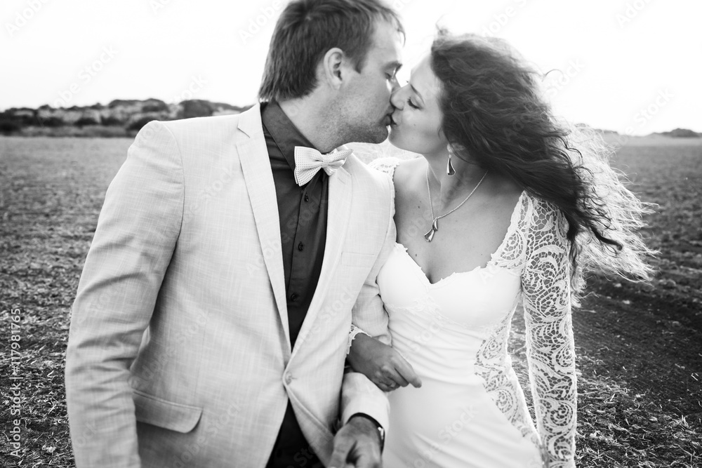 Black and white picture of a couple kissing in the desert Black and white picture of a couple kissing in the desert