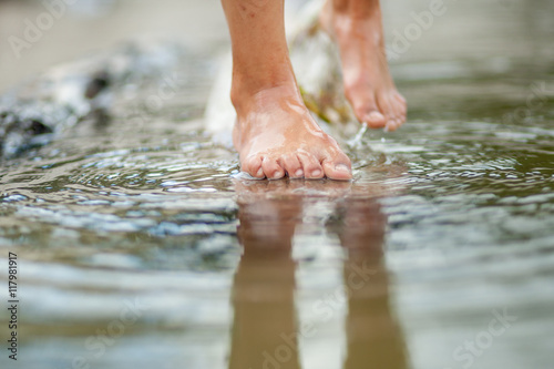 Girls legs on the water