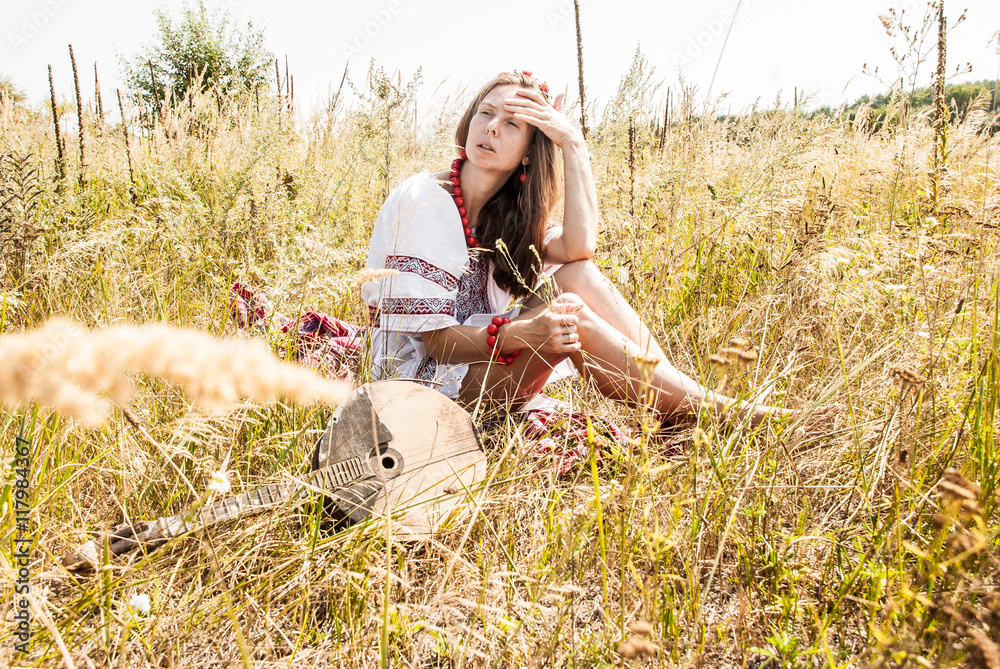 Pretty ukrainian woman dressed in embroidered clothes in the field Pretty ukrainian woman dressed in embroidered clothes in the field