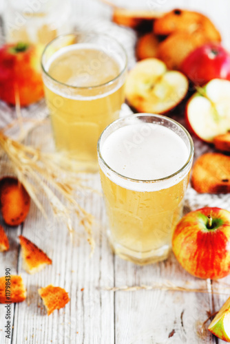  summer and autumn cooling drink , white brew or kvass with honey , apples , raisins and bread on wooden background