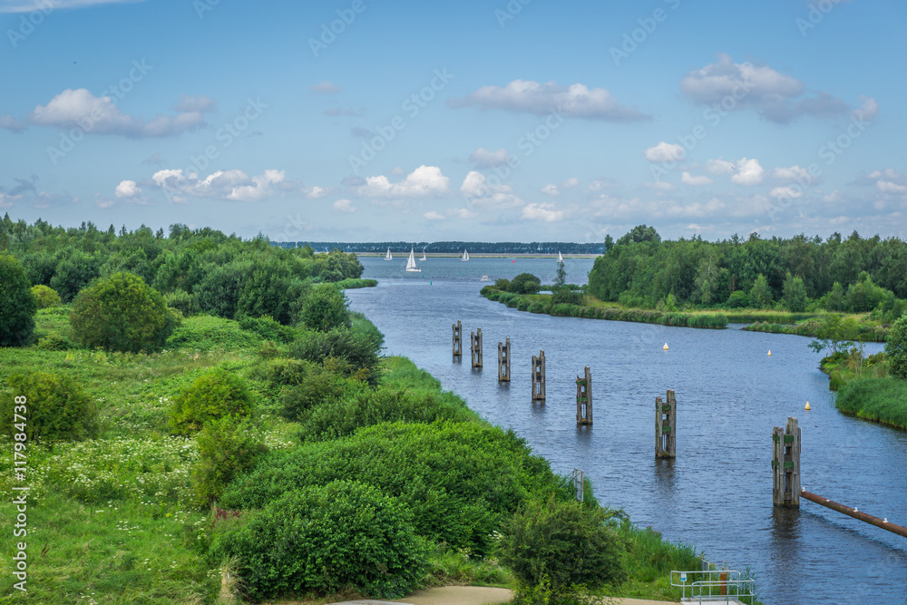 beautiful river landscape with poles and boats sky view