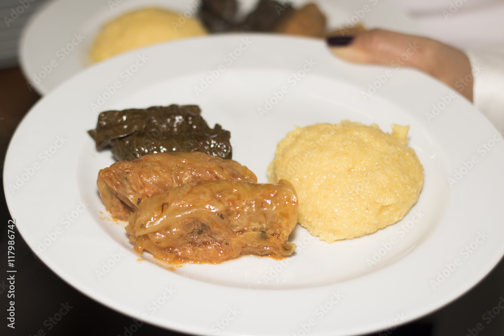 Stuffed vine and cabbage leaves with polenta