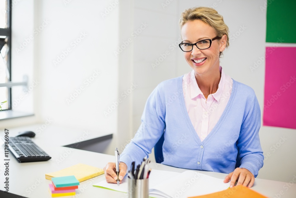 Teacher checking book in classroom Teacher checking book in classroom