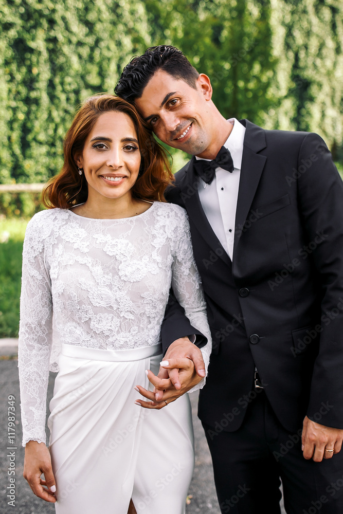 Picture of stunning Italian couple standing in the park Picture of stunning Italian couple standing in the park