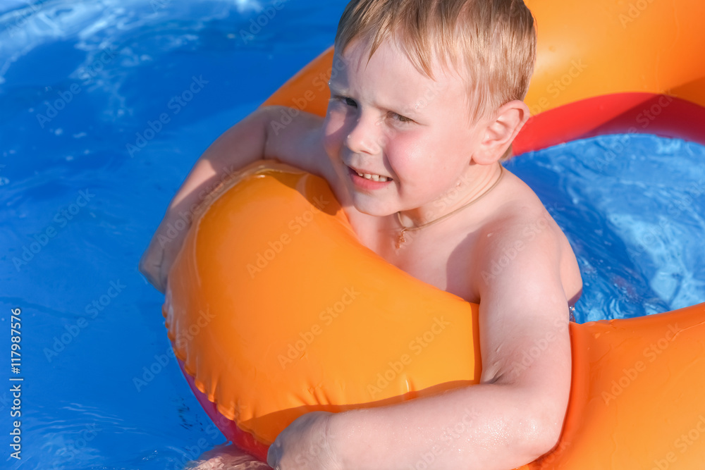 little boy on an inflatable circle in the water little boy on an inflatable circle in the water