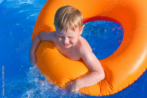 little boy on an inflatable circle in the water © dbrus
