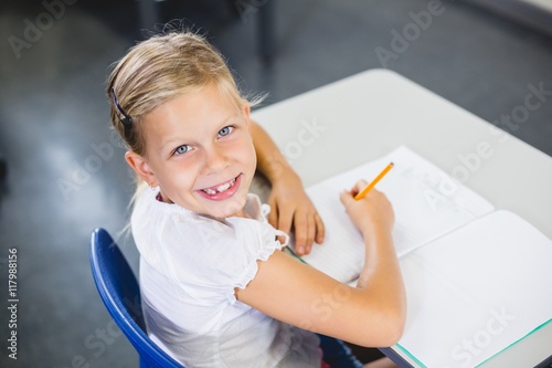 Schoolgirl smiling in classroom