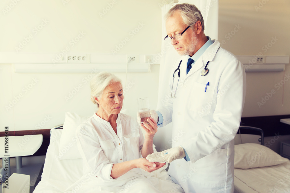 doctor giving medicine to senior woman at hospital doctor giving medicine to senior woman at hospital