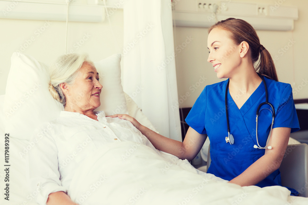 Fototapeta premium doctor or nurse visiting senior woman at hospital