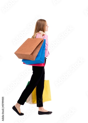 back view of going woman with shopping bags . beautiful girl in motion. backside view of person. Rear view people collection. Isolated over white background. The woman is left businessman with