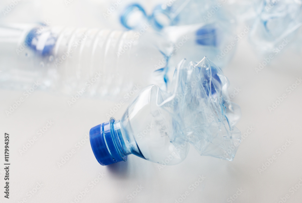 close up of empty used plastic bottles on table close up of empty used plastic bottles on table