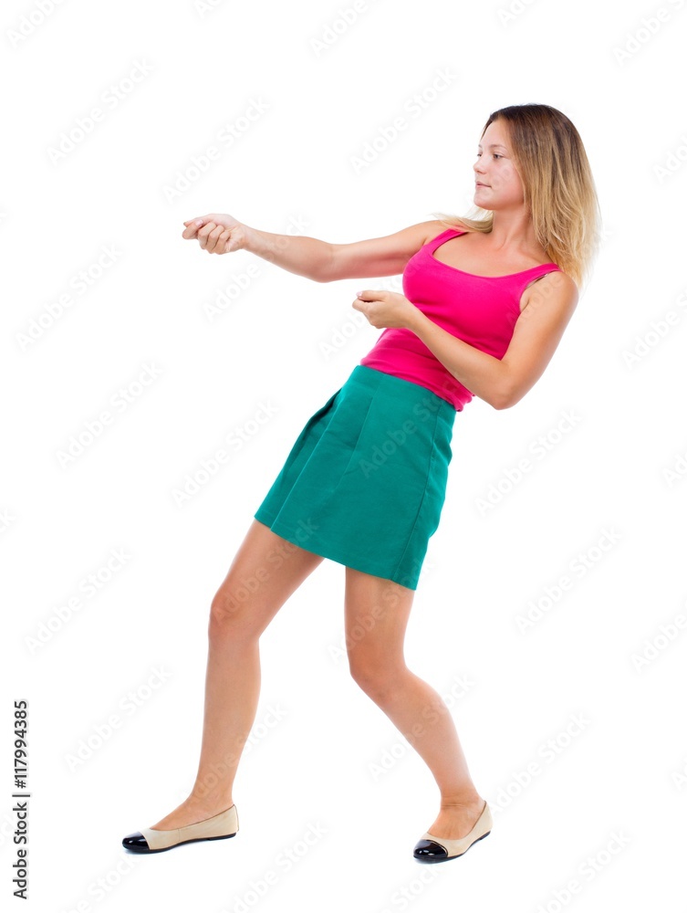 back view of standing girl pulling a rope from the top or cling to something. girl watching. Rear view people collection. backside view of person. Isolated over white background. The blonde in a back view of standing girl pulling a rope from the top or cling to something. girl watching. Rear view people collection. backside view of person. Isolated over white background. The blonde in a