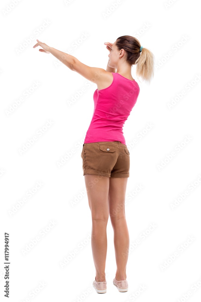 Back view of pointing woman. beautiful girl. Rear view people collection. backside view of person. Isolated over white background. Blonde in brown shorts saw something interesting on the left. Back view of pointing woman. beautiful girl. Rear view people collection. backside view of person. Isolated over white background. Blonde in brown shorts saw something interesting on the left.