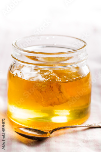Honeycomb in jar with honey.