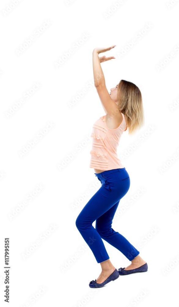 back view of woman protects hands from what is falling from above. woMan holding a heavy load Rear view people collection. backside view of person. Isolated over white background. The blonde in a back view of woman protects hands from what is falling from above. woMan holding a heavy load Rear view people collection. backside view of person. Isolated over white background. The blonde in a