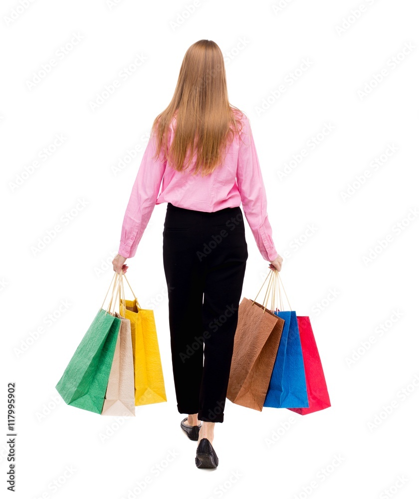 back view of going  woman  with shopping bags . beautiful girl in motion.  backside view of person.  Rear view people collection. Isolated over white background. Woman businessman went off with a lot