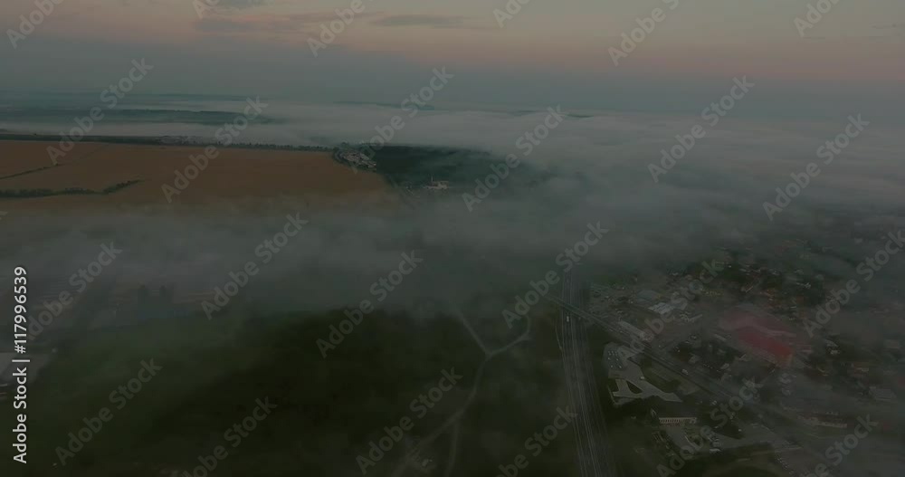 Aerial view of highway, forests and fields, village. Misty morning. Aerial view of highway, forests and fields, village. Misty morning.