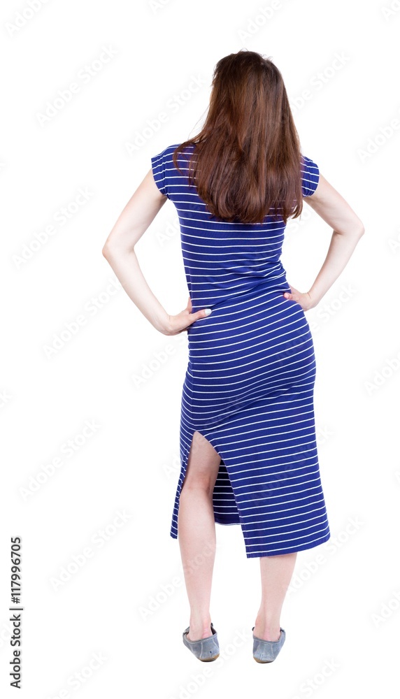back view of standing young beautiful woman. girl watching. Rear view people collection. backside view of person. Isolated over white background. A girl in a long blue dress put her hands on her back view of standing young beautiful woman. girl watching. Rear view people collection. backside view of person. Isolated over white background. A girl in a long blue dress put her hands on her