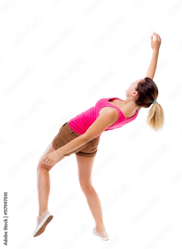 Balancing young woman. or dodge falling woman. Rear view people collection. backside view of person. Isolated over white background. The girl in brown shorts and a pink shirt falls on his back. Balancing young woman. or dodge falling woman. Rear view people collection. backside view of person. Isolated over white background. The girl in brown shorts and a pink shirt falls on his back.