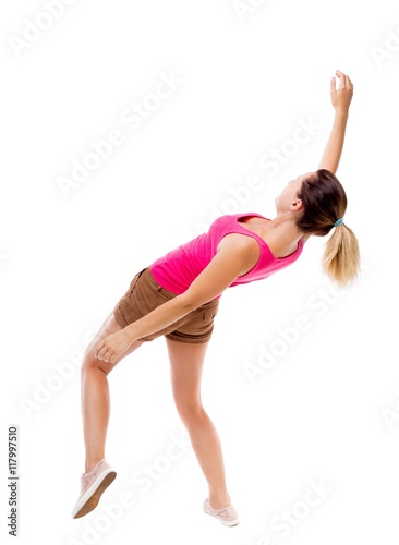 Balancing young woman. or dodge falling woman. Rear view people collection. backside view of person. Isolated over white background. The girl in brown shorts and a pink shirt falls on his back.