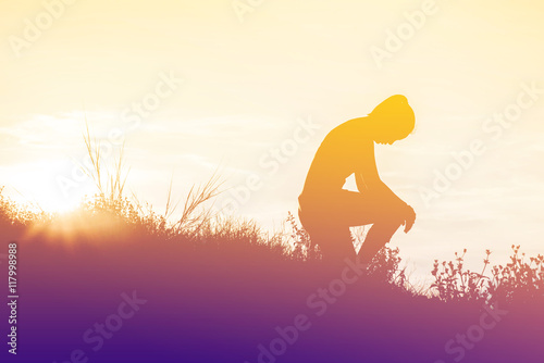silhouette woman knee down with her hands