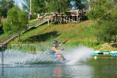 Man does wakeboarding sport.