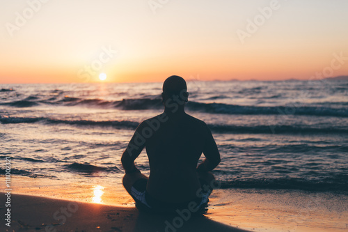 Fotografi filtered colors on sunset at the beach, man thinking and watching