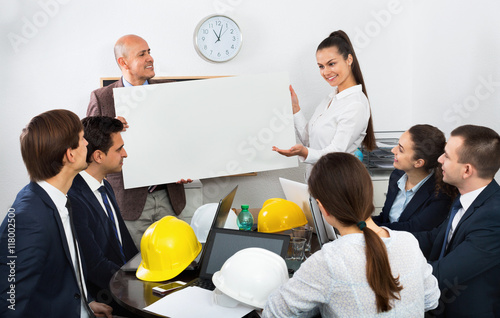 Positive spirited  colleagues discussing new development plan photo