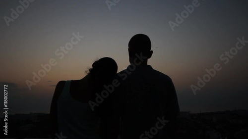 Young couple hugging at sunset