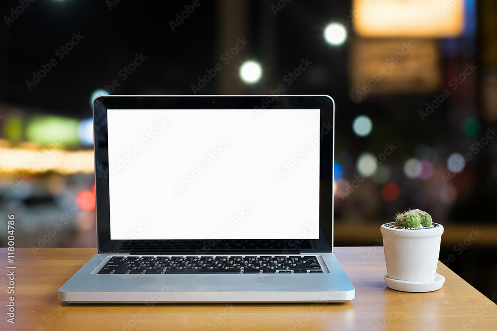 Blank screen of Laptop on wood work table in blurred night citys Blank screen of Laptop on wood work table in blurred night citys