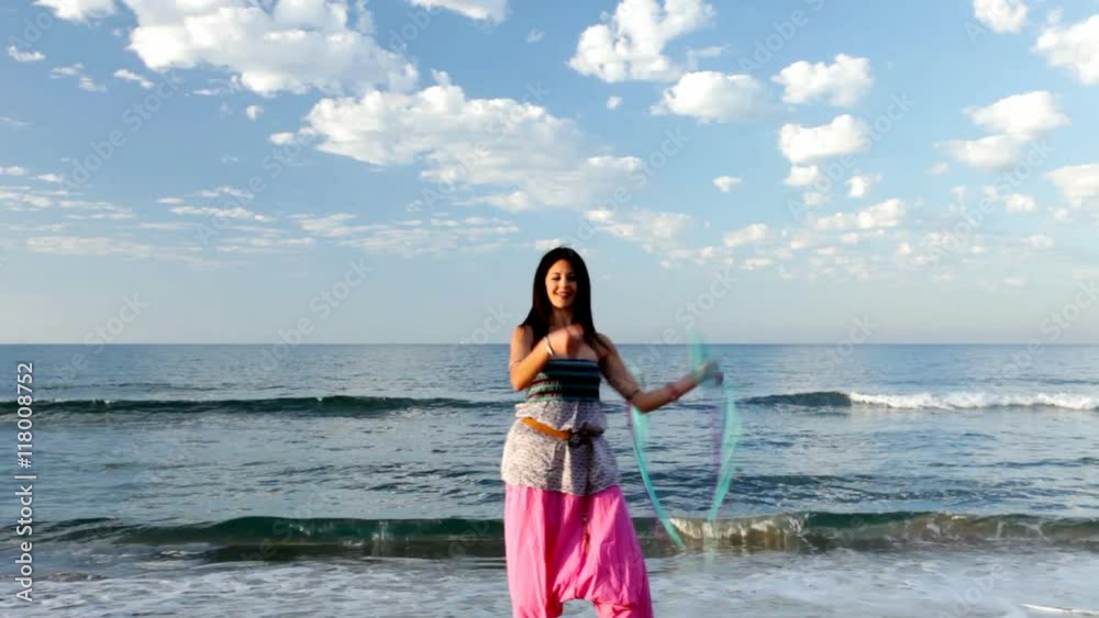 women playing with poi at the beach