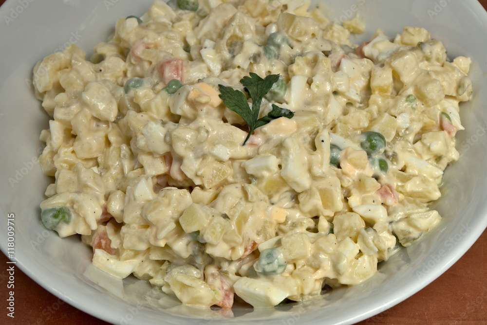 Homemade potato salad in white ceramic plate Homemade potato salad in white ceramic plate