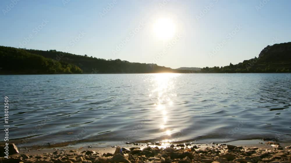 sun setting over a lake in france sun setting over a lake in france